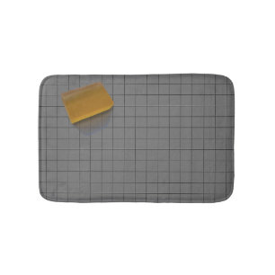 Clear Orange Soap on a Grey Tile Floor Bath Mat