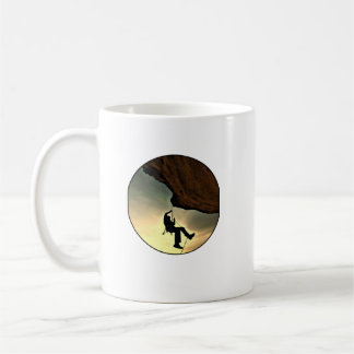Climbing mountain man at sunset coffee mug