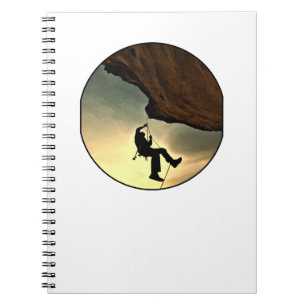 Climbing mountain man at sunset notebook