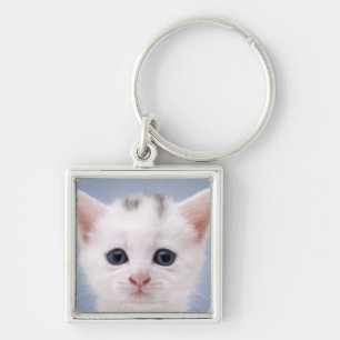 Close up image of a predominately white faced keychain
