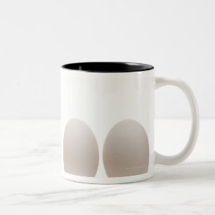 Close-up of a baby chick with three eggs Two-Tone coffee mug