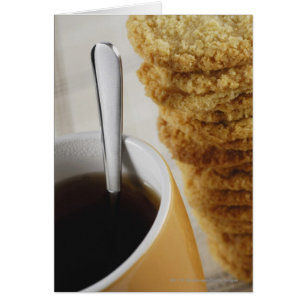 Close-up of a cup of coffee with cookies