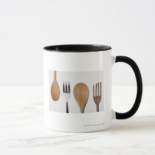 Close-up of a fork with a wooden spoon mug