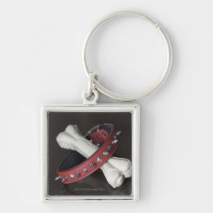Close-up of a pet collar and a dog bone keychain