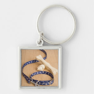 Close-up of a pet collar and a leash with dog keychain