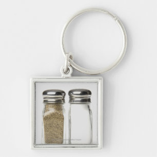 Close-up of a salt and a pepper shaker keychain