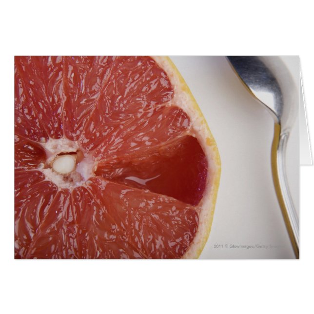Close-up of a slice of orange and a spoon (Front Horizontal)