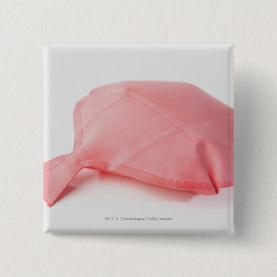 Close-up of a whoopee cushion 2 inch square button