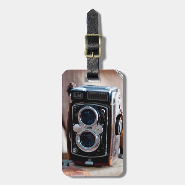 Close-up of an antique camera luggage tag (Front Vertical)