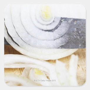 close-up of an onion, being cut into slices square sticker