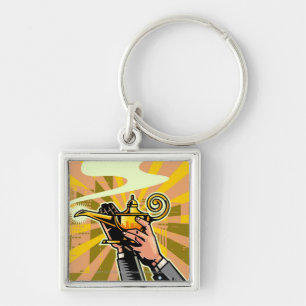 Close-up of businessman holding magic lamp keychain