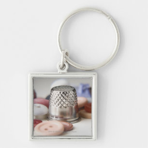 Close-up of buttons with a metal cap keychain