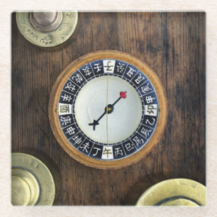 Close Up Of Chinese Compass And Gold Weights Glass Coaster