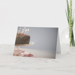 Close up of chocolate birthday cake with candles card