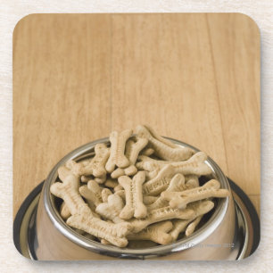 Close-up of dog biscuits in a dog bowl coaster