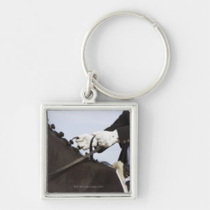 close-up of dressage horse with rider keychain