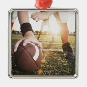 Close up of football centre preparing to snap metal ornament