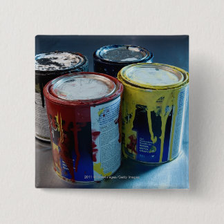 Close-up of four paint cans 2 inch square button