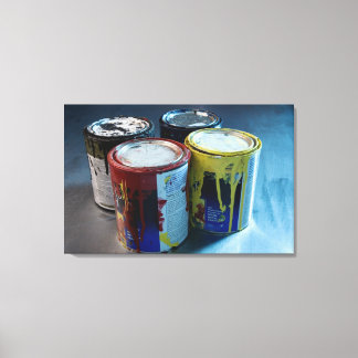 Close-up of four paint cans canvas print