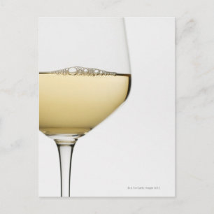 Close up of glass of white wine on white postcard