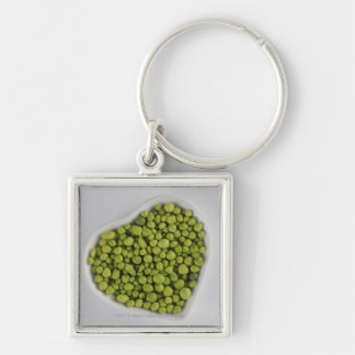 Close-up of green pebbles in a heart shape bowl keychain