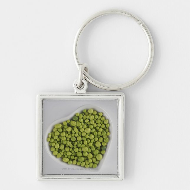 Close-up of green pebbles in a heart shape bowl keychain (Front)