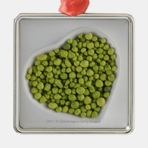 Close-up of green pebbles in a heart shape bowl metal ornament