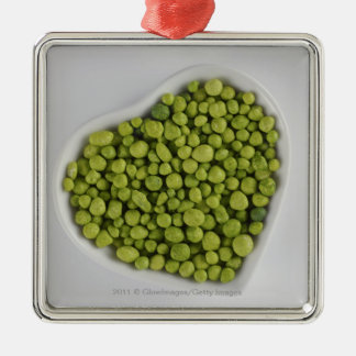Close-up of green pebbles in a heart shape bowl metal ornament