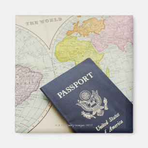 Close-up of passport lying on map magnet