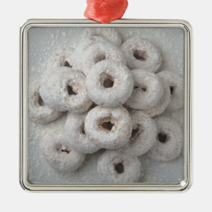 Close-up of powdered doughnuts in a plate metal ornament