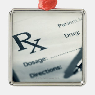 Close up of prescription pad and pen metal ornament
