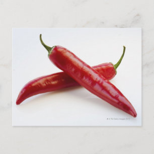 Close up of red chili peppers on white postcard