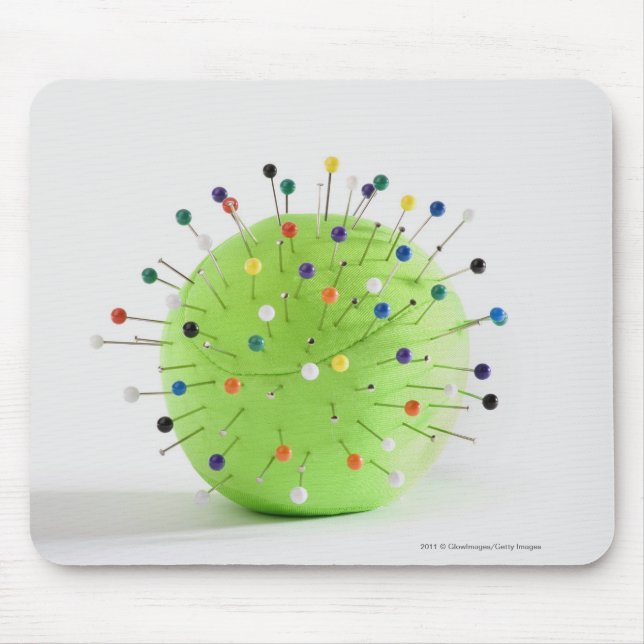 Close-up of straight pins inserted into a ball mouse pad (Front)