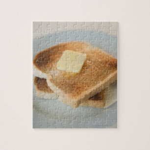 Close up of toasts with butter on plate jigsaw puzzle
