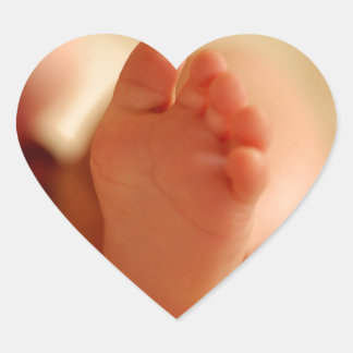 Close up photo of baby feet heart sticker