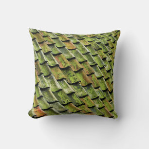 Close-up photo of green shingle roof throw pillow