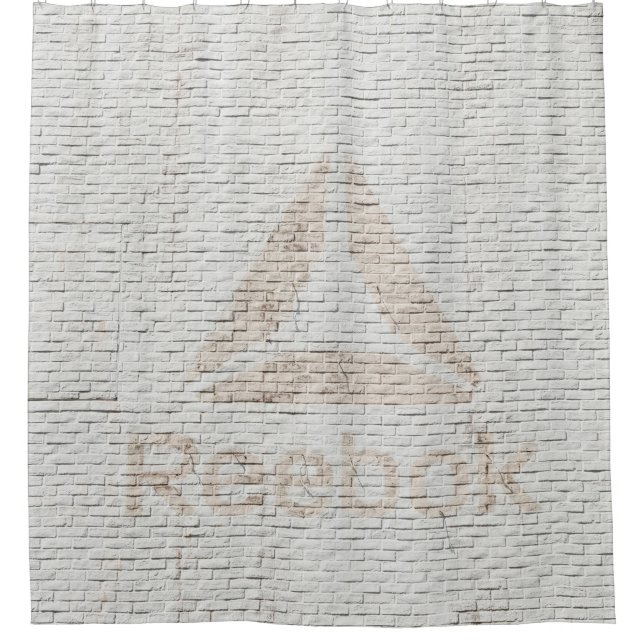 Close-up photo of Reebok logo on wall (Front)
