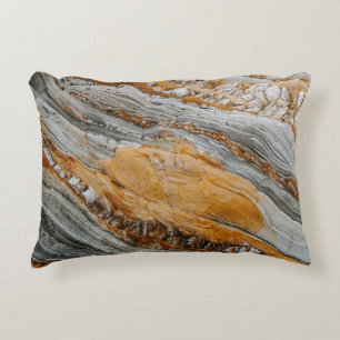 Close-up photography of grey and orange stones accent pillow