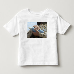 Close-up view of a soldier cradling a munition toddler t-shirt