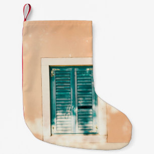 Closed green wooden door small christmas stocking