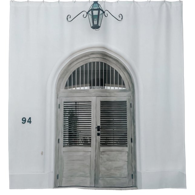 CLOSED GREY WOODEN DOOR BELOW BLACK LIGHT SCONCE (Front)