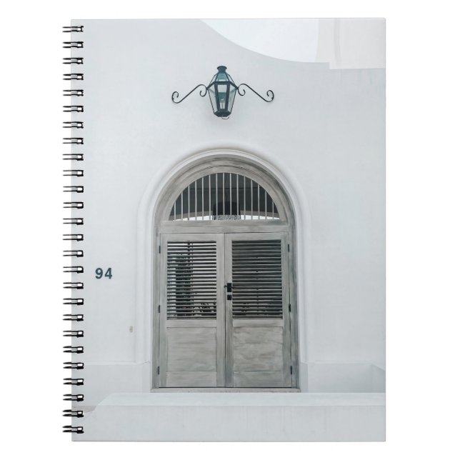 CLOSED GREY WOODEN DOOR BELOW BLACK LIGHT SCONCE NOTEBOOK (Front)