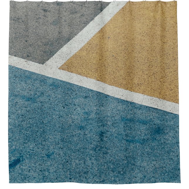 Closeup grey, yellow, and blue painted pavement (Front)