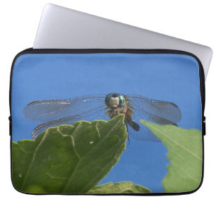 Closeup of a dragonfly against a bright blue sky laptop sleeve