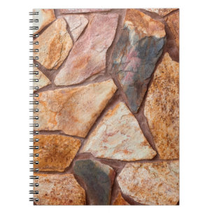 Closeup of a stone wall as a backgroundwallpaper,p notebook