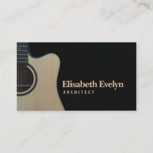 Closeup of cutaway acoustic guitar over black business card
