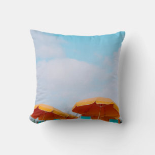 Closeup photo of lounger chairs and beach umbrella throw pillow