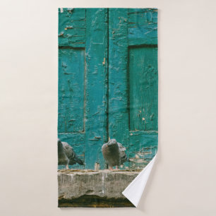 CLOSEUP PHOTO OF TWO GRAY PIGEONS ON GRAY CONCRETE BATH TOWEL