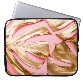 Closeup view of natural gold painted monstera trop laptop sleeve
