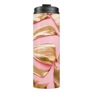 Closeup view of natural gold painted monstera trop thermal tumbler